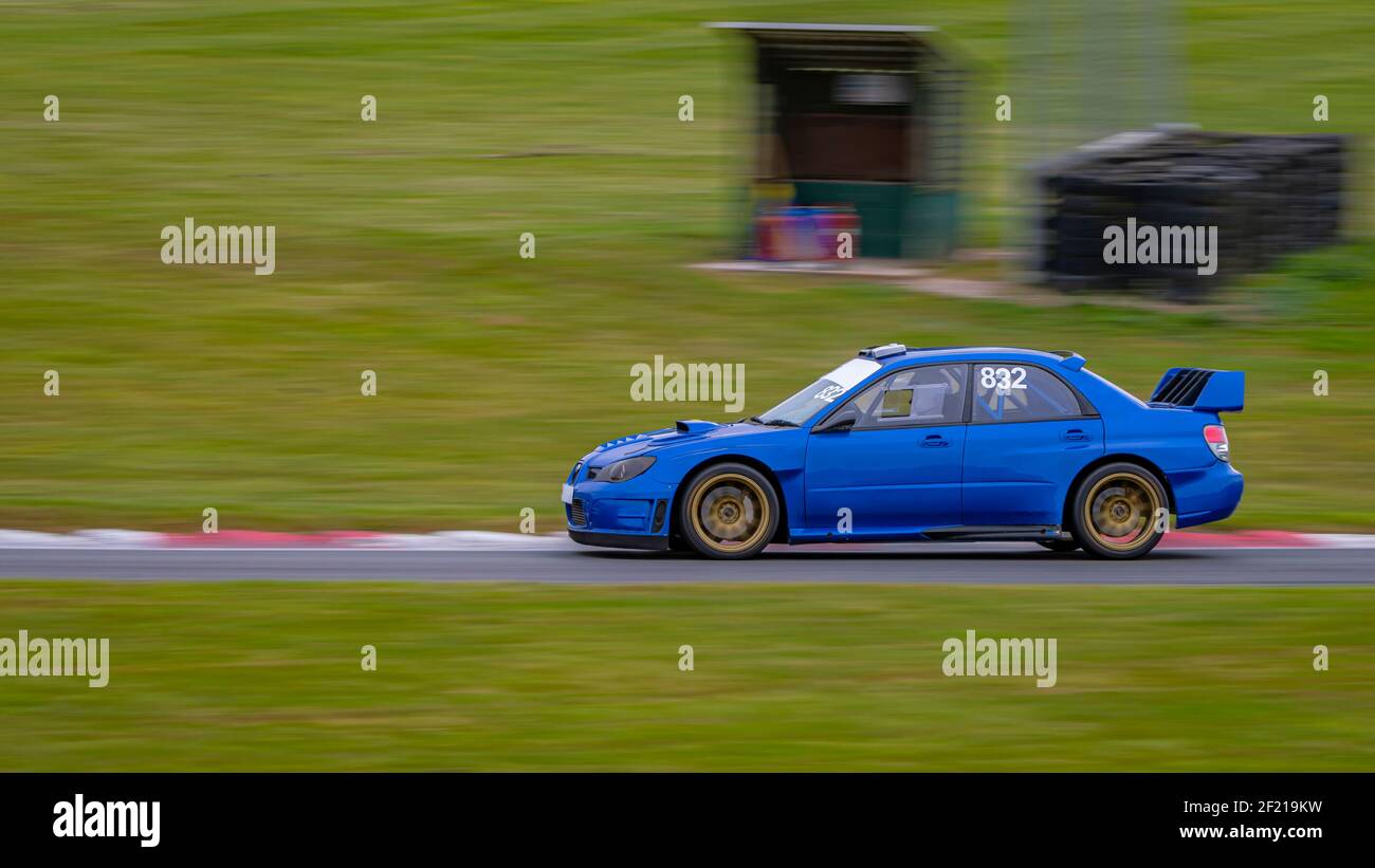 a-panning-shot-of-a-racing-car-as-it-circuits-a-track-2F219KW.jpg