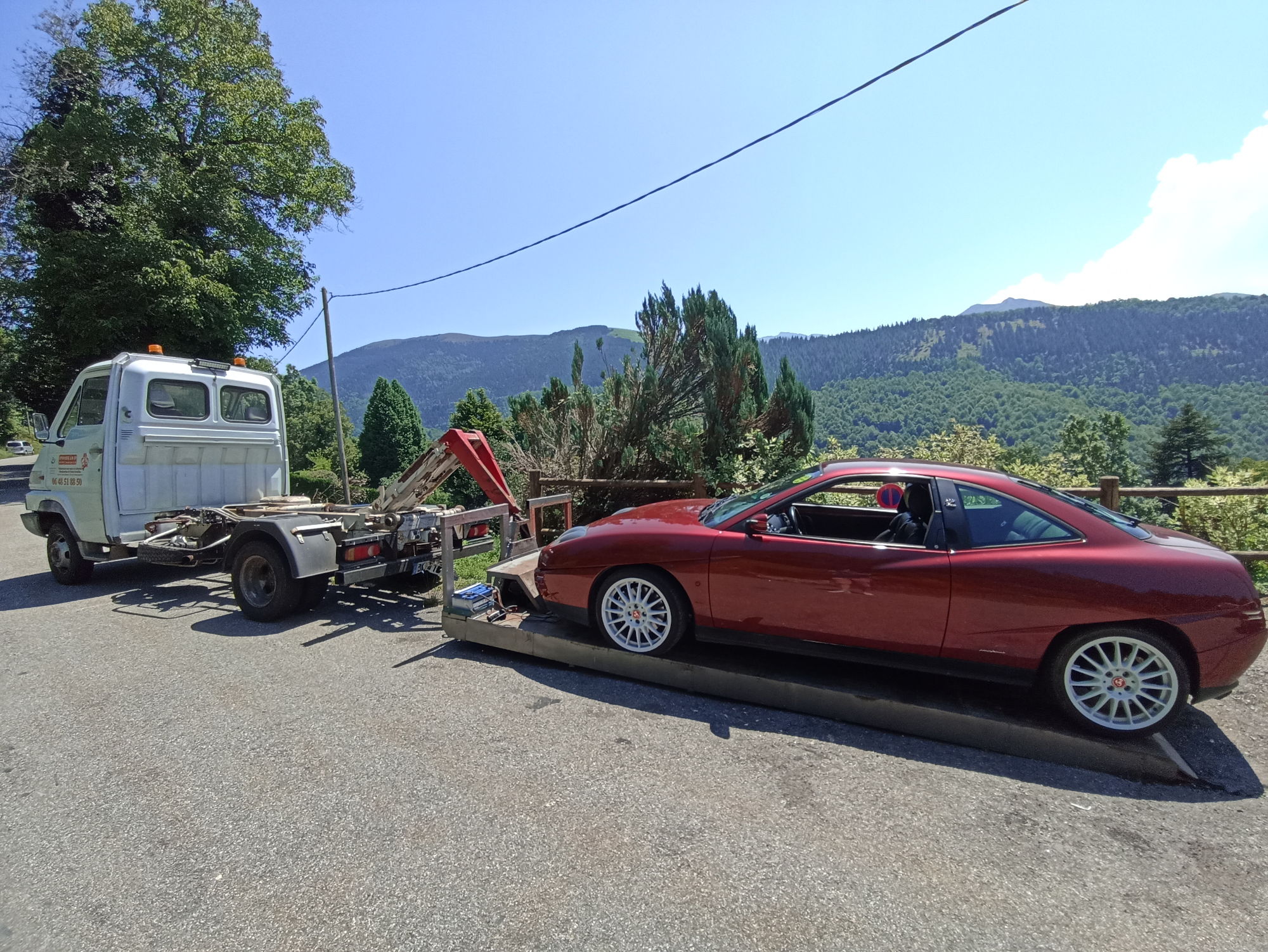 An Italian car getting towed - it's natural habitat.