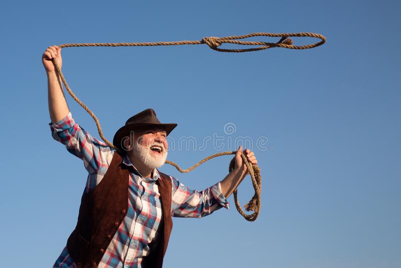 old-cowboy-lasso-rope-ranch-rodeo-bearded-western-man-brown-jacket-hat-catching-horse-cow-2151...jpg