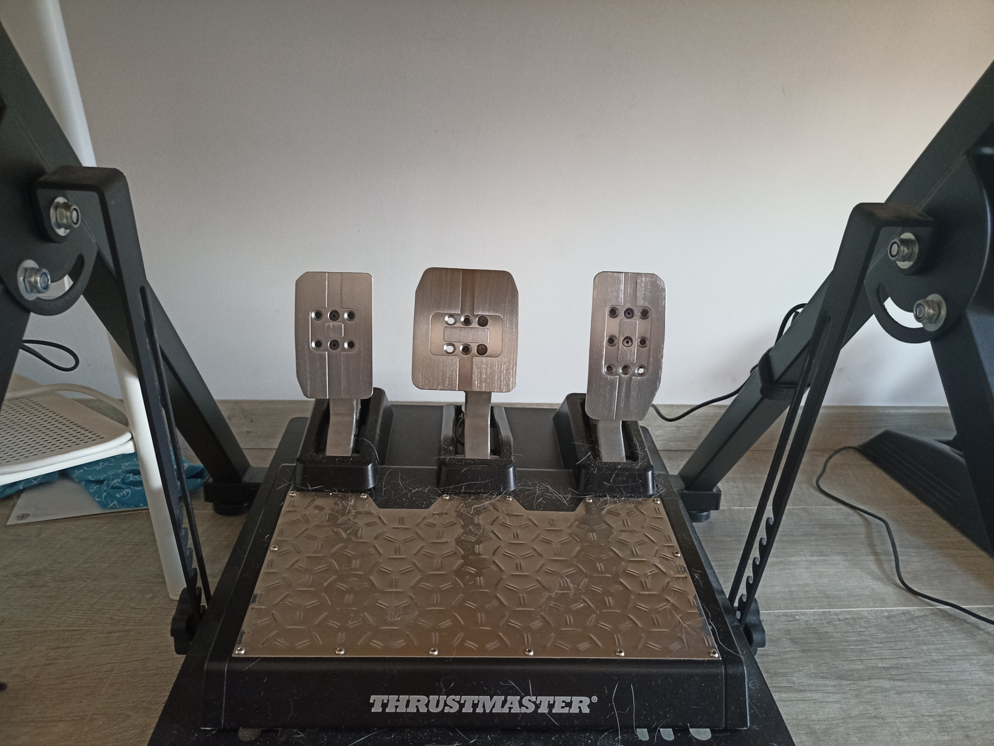 A new, yet already dusty set of Thrustmaster T-LCM load cell pedals.